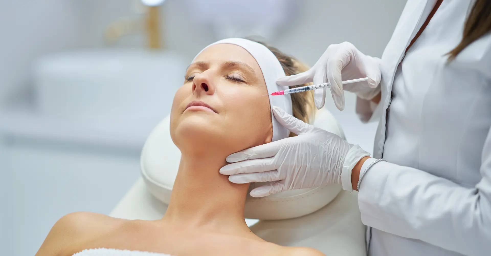 A woman getting her face waxed at the spa