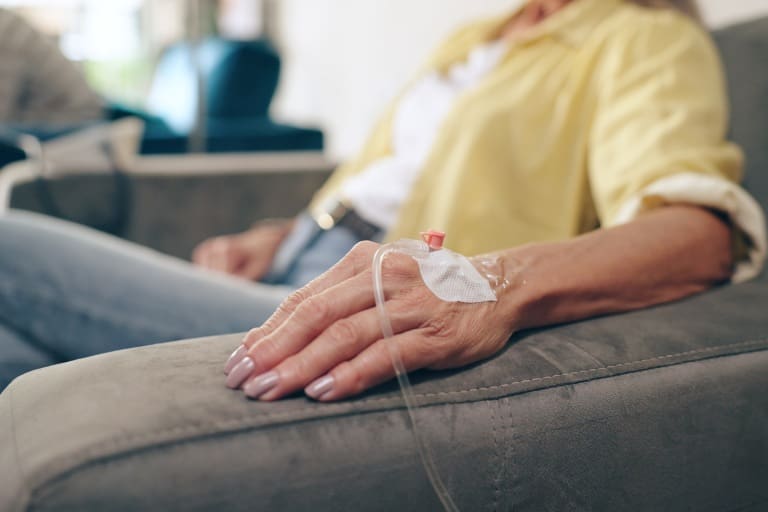 A person with an iv in their hand.